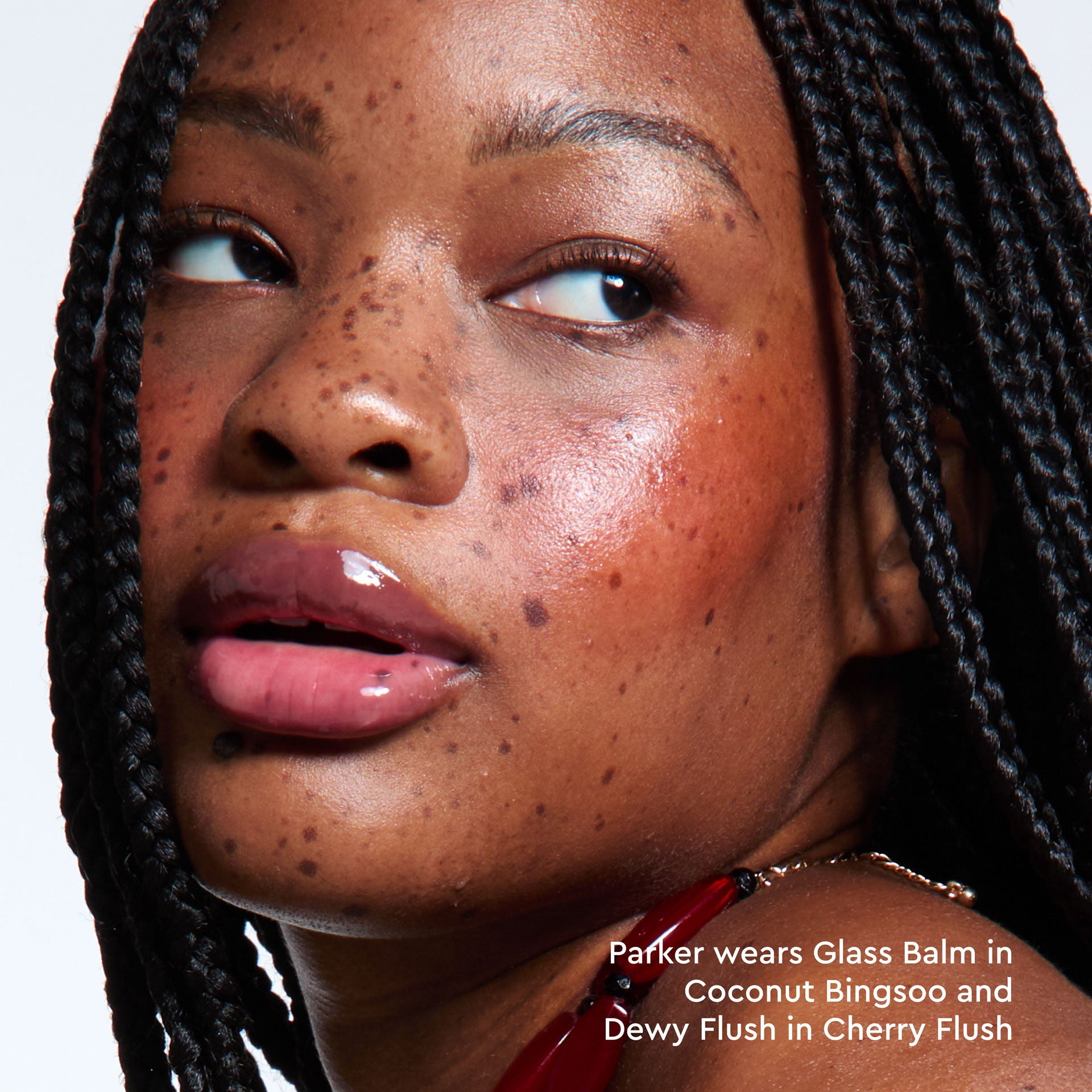Model applying Glass Balm in Coconut Bingsoo, showing the sheer cool-brown tint blended on bare lips.
