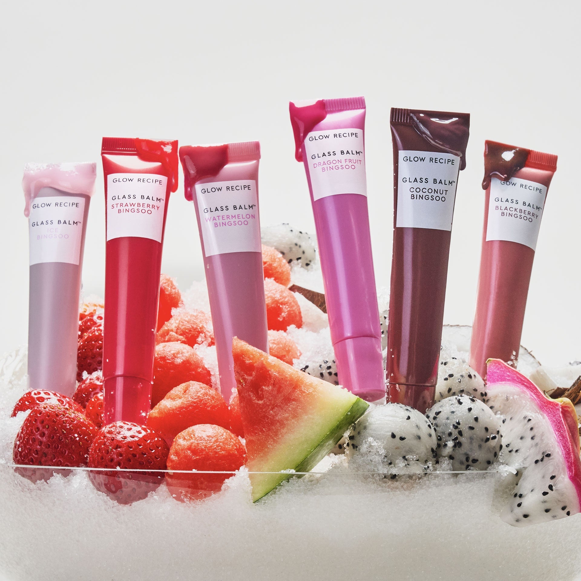 Glow Recipe Glass Balm Lip Treatment full assortment lineup in Dragon Fruit Bingsoo, a sheer bright pink tint.