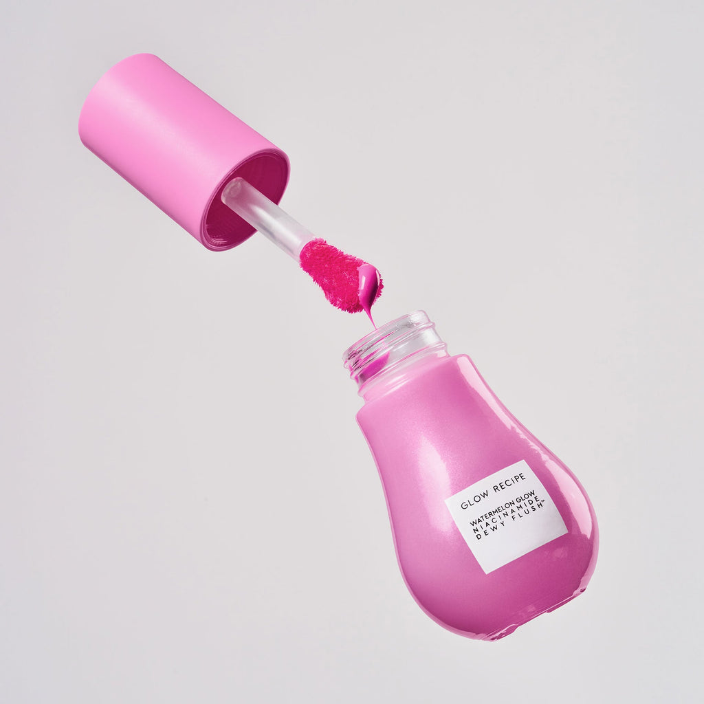 Dragon Fruit Flush Dewy Flush bottle stands upright, showcasing its sheer bright pink tint through clear glass.