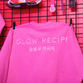 Pink sweatshirt with 'GLOW RECIPE' text on a pink background