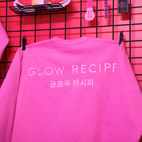 Pink sweatshirt with 'GLOW RECIPE' text on a pink background