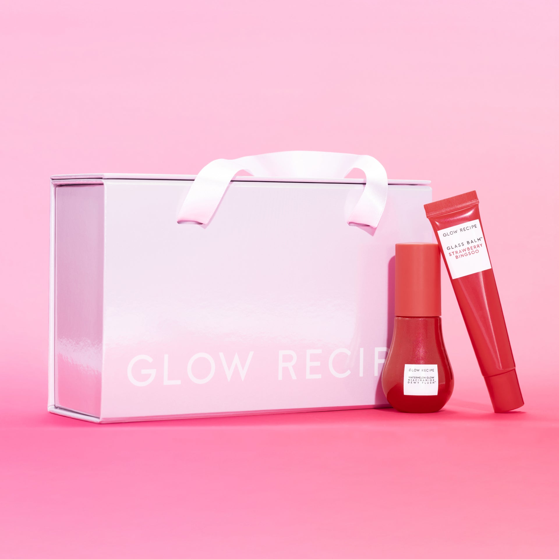 Strawberry + Cherry Lip & Cheek Kit packaging shot showing the tint duo beside its iridescent gift box.