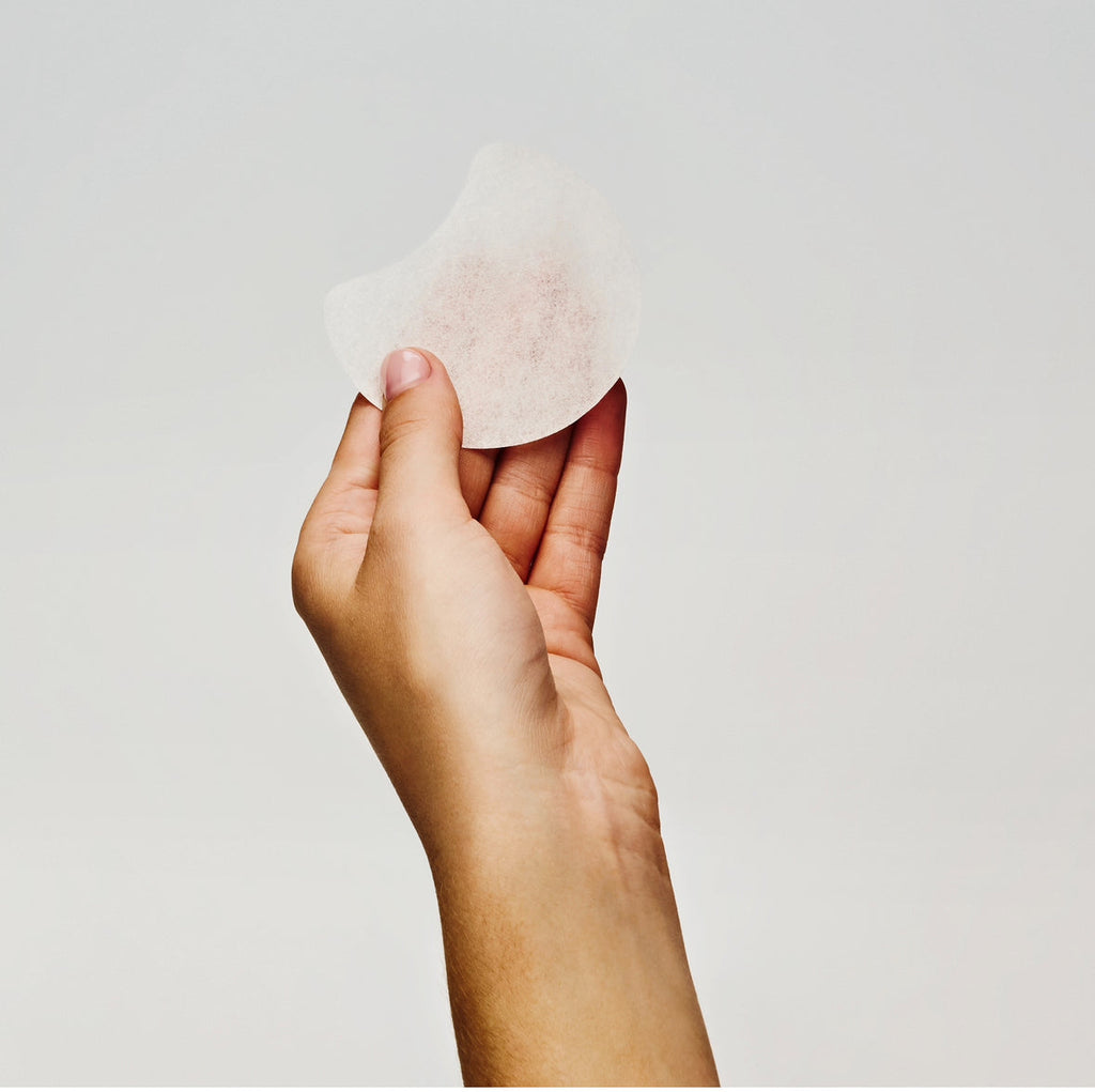 Glow Recipe Dew It Yourself Toner Pads Masking Kit close-up of a hydrating toner pad pressed onto the skin.