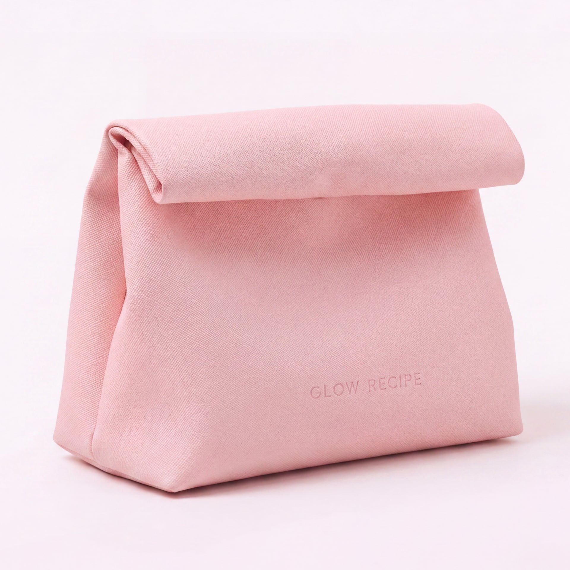 Pink cosmetic bag with 'GLOW RECIPE' branding on a light pink background