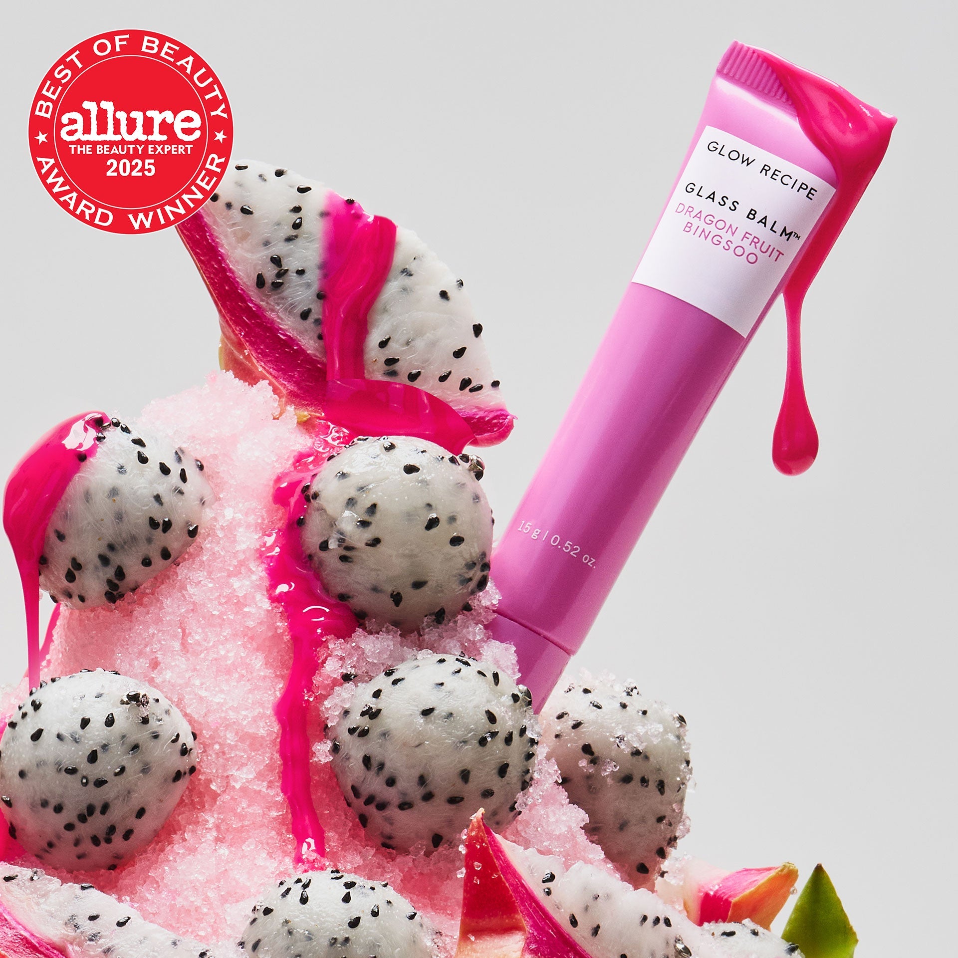 Allure Best of Beauty seal badge over the Glass Balm tube in Dragon Fruit Bingsoo, a sheer bright pink shade.