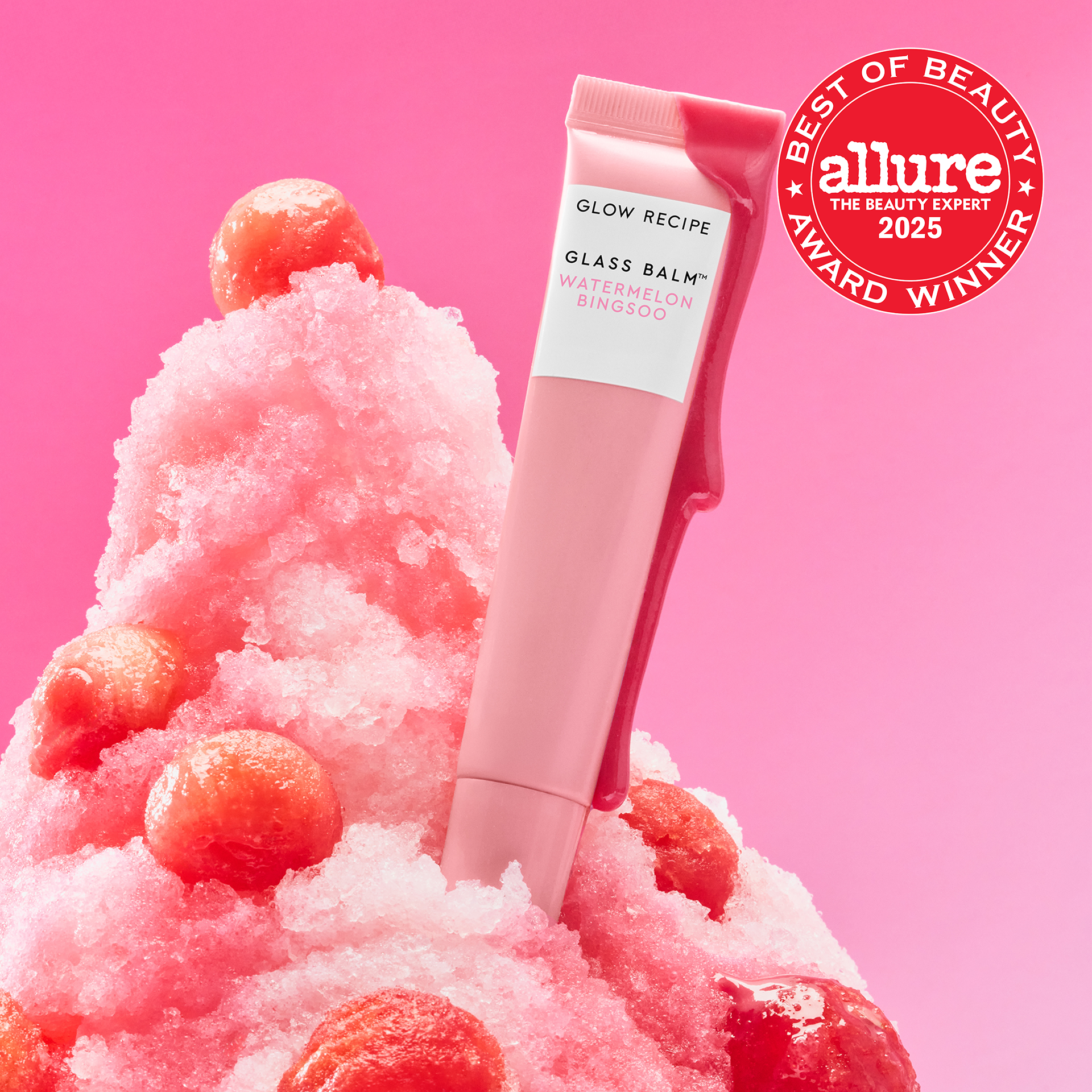 Allure Best of Beauty seal badge over the Glass Balm tube in Watermelon Bingsoo, a sheer soft pink shade.