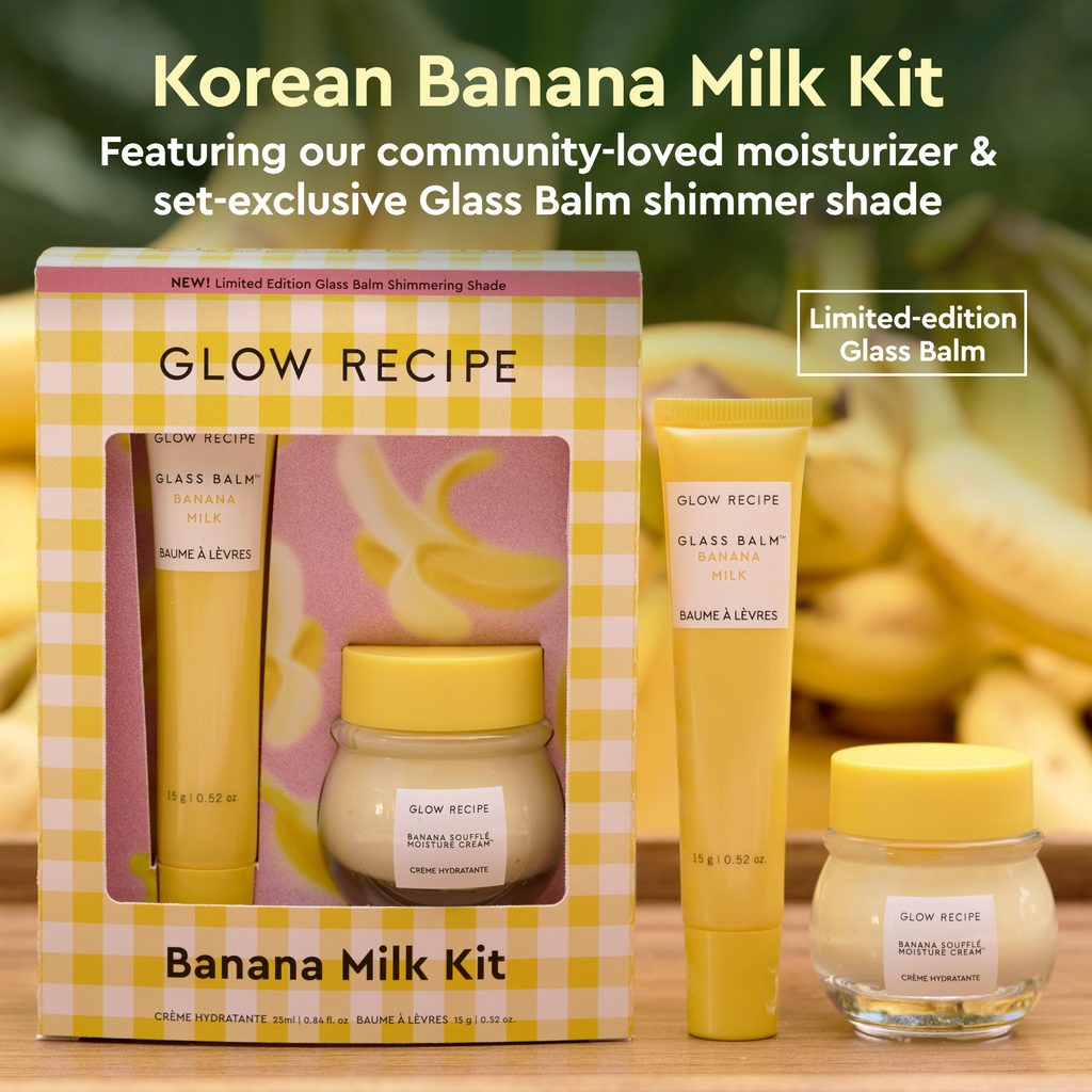 Glow Recipe Banana Milk Kit with packaging, glass balm, and cream on a wooden surface with banana background.