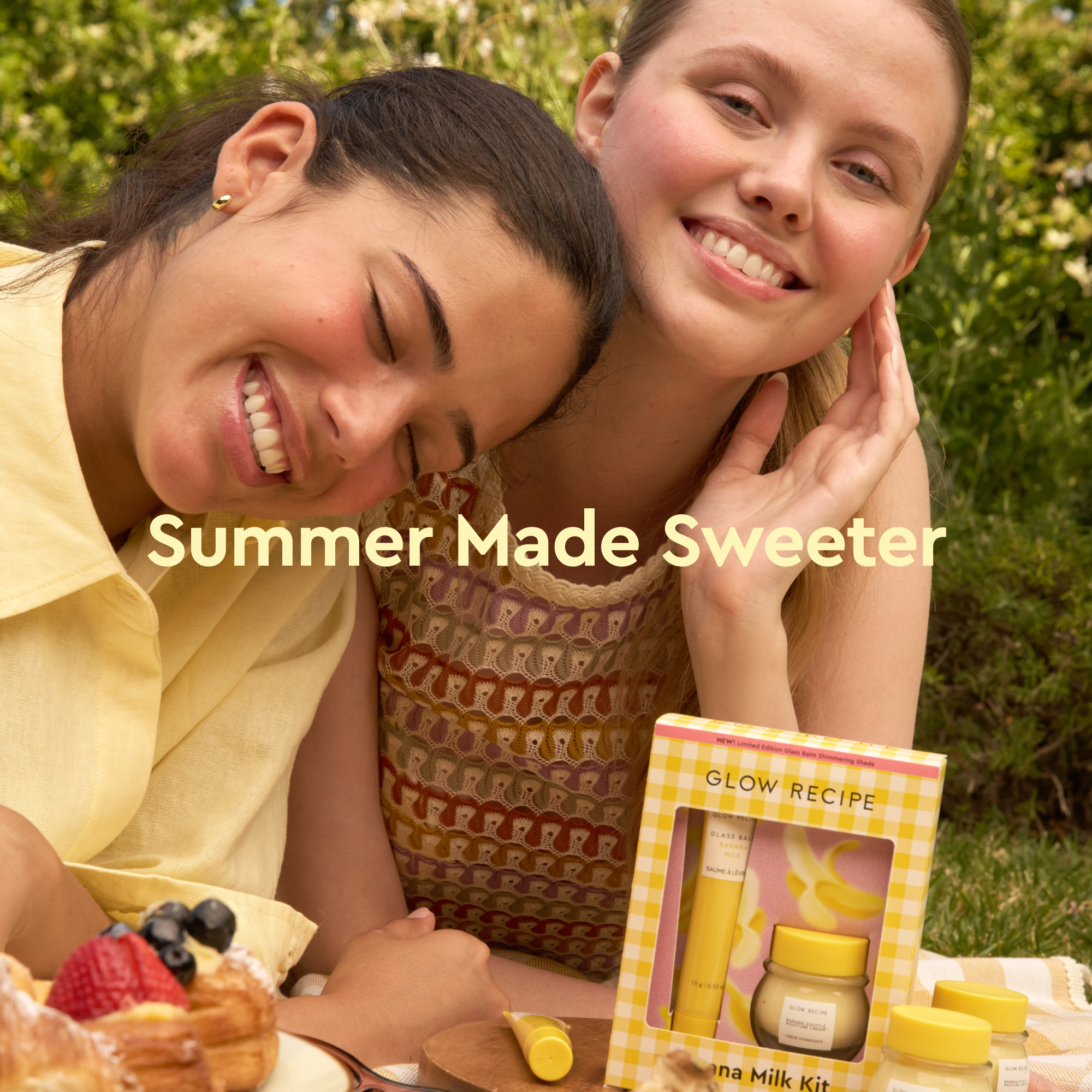 Two women enjoying a picnic with a Glow Recipe product in the foreground.
