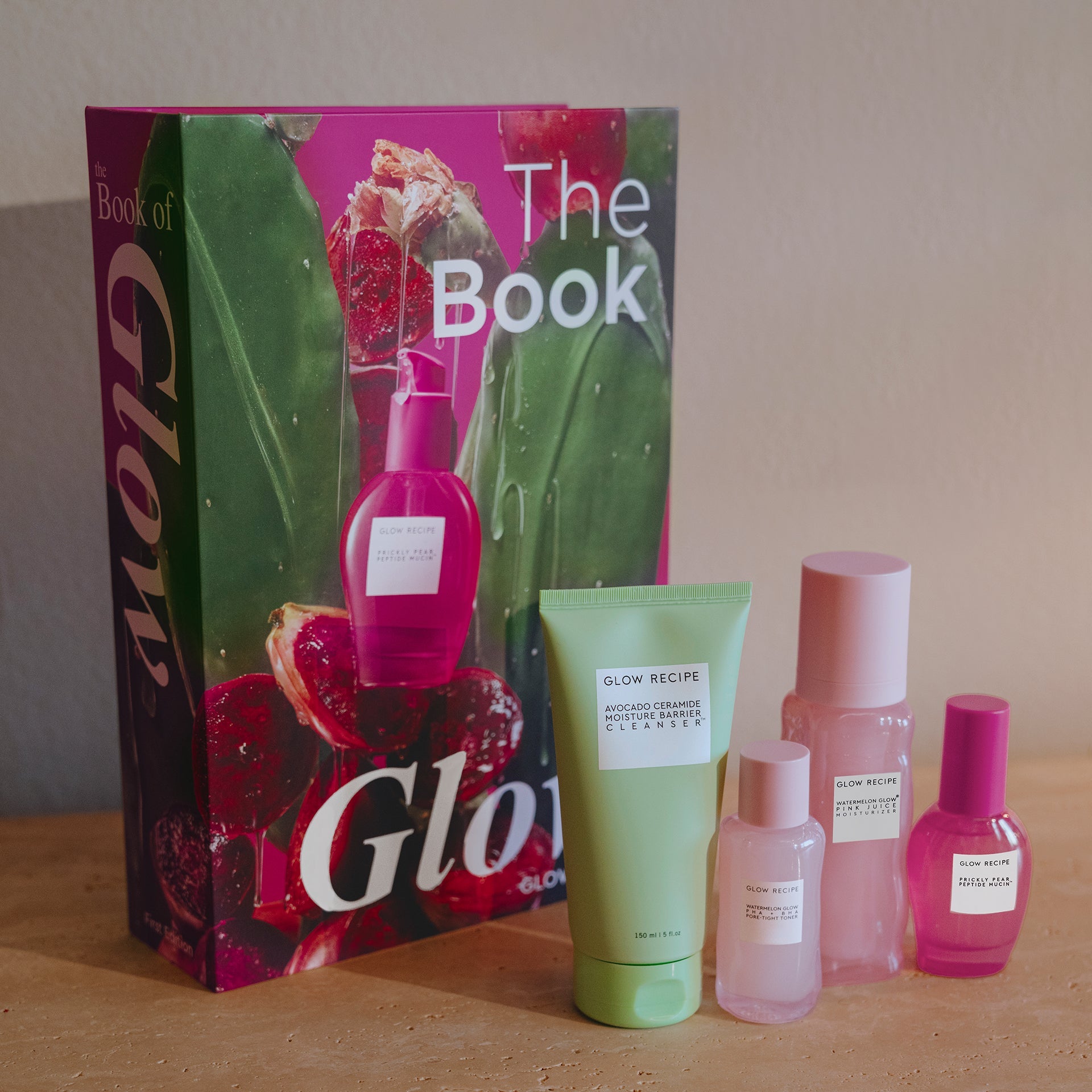Glow skincare products and 'The Book of Glow' on a wooden surface