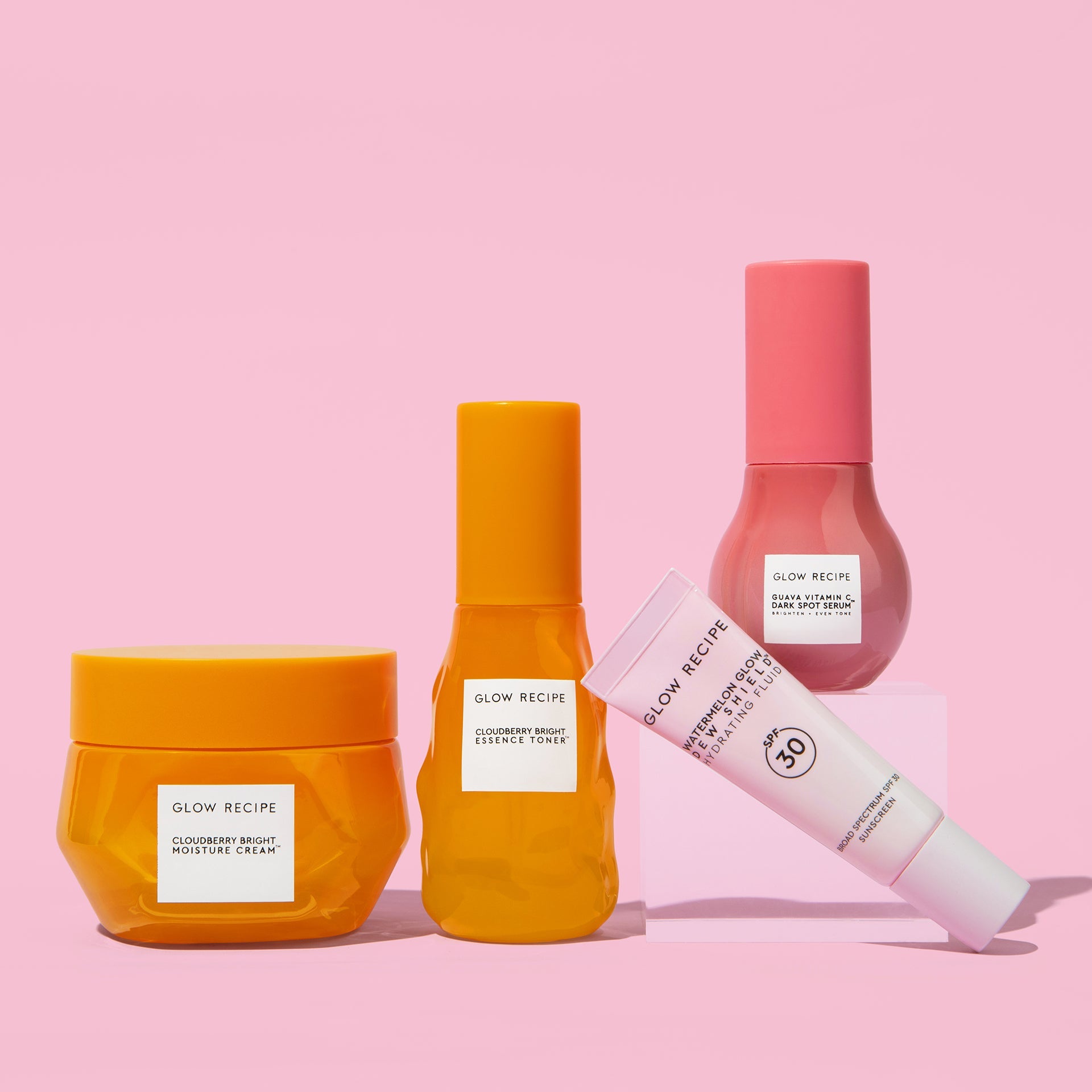 Four skincare products from Glow Recipe on a pink background