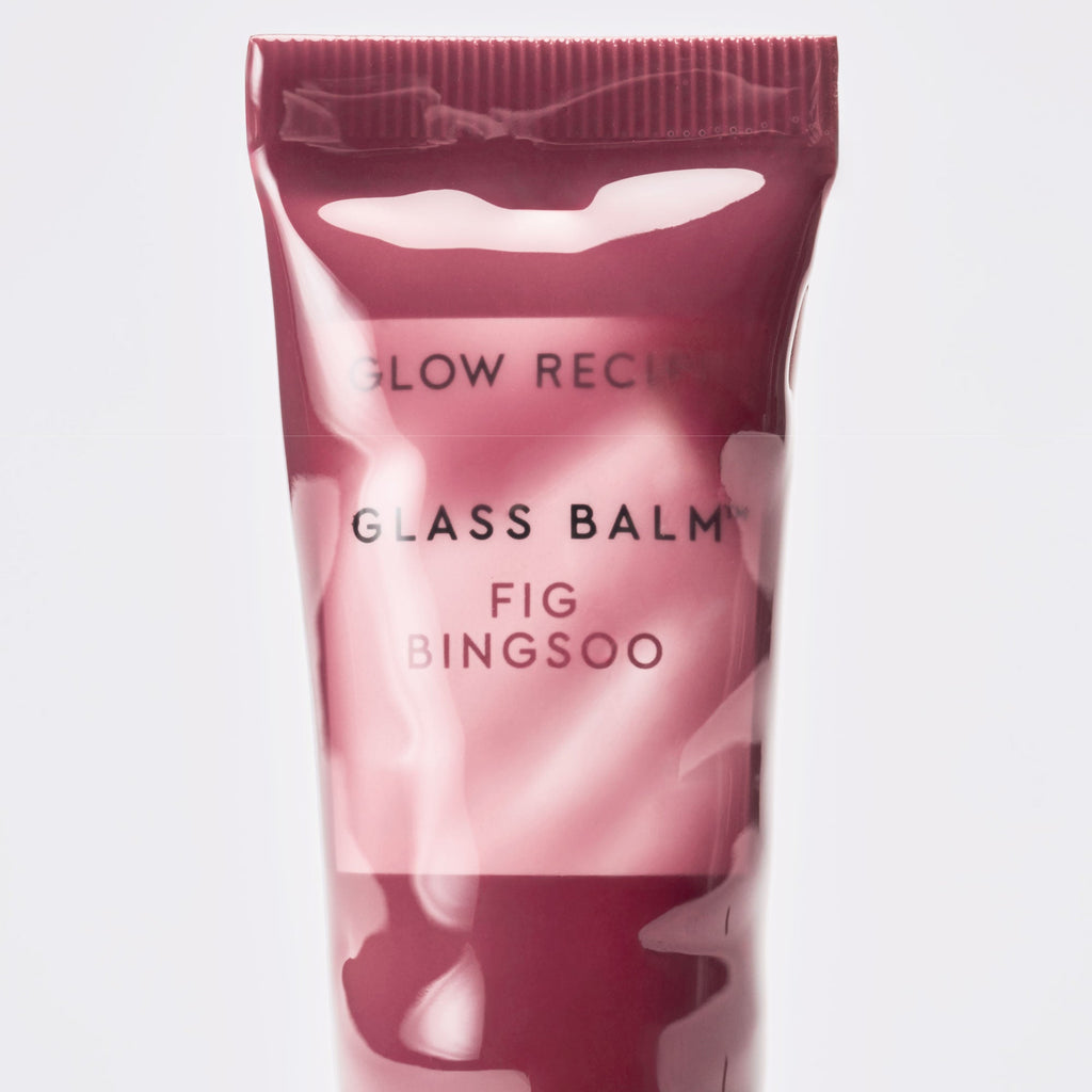 Stylized flat-lay of the Glass Balm tube in Fig Bingsoo arranged with dessert-inspired props.