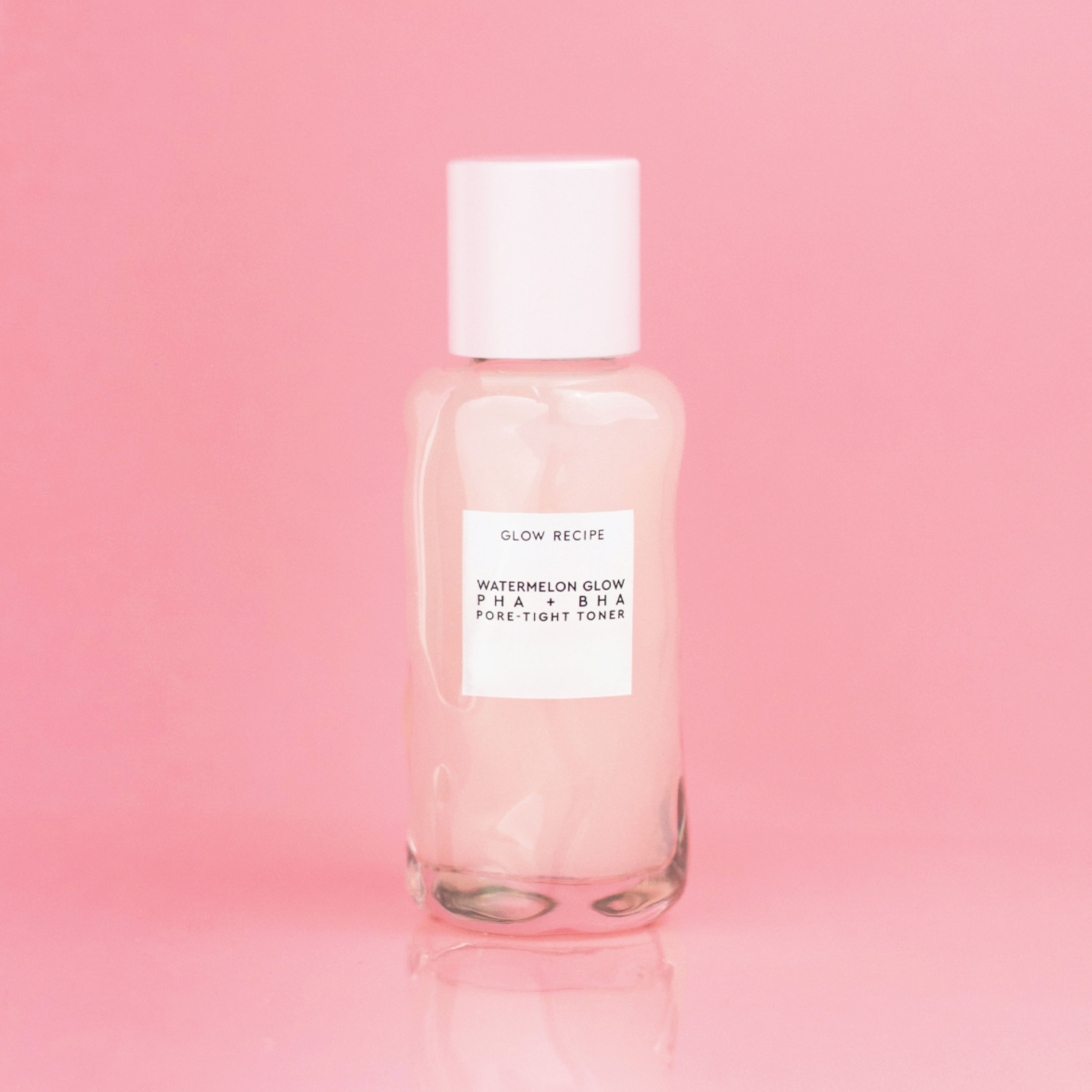 Mini Watermelon Glow PHA + BHA Pore-Tight Toner bottle from the Real Glass Skin Kit shown on a pink background.