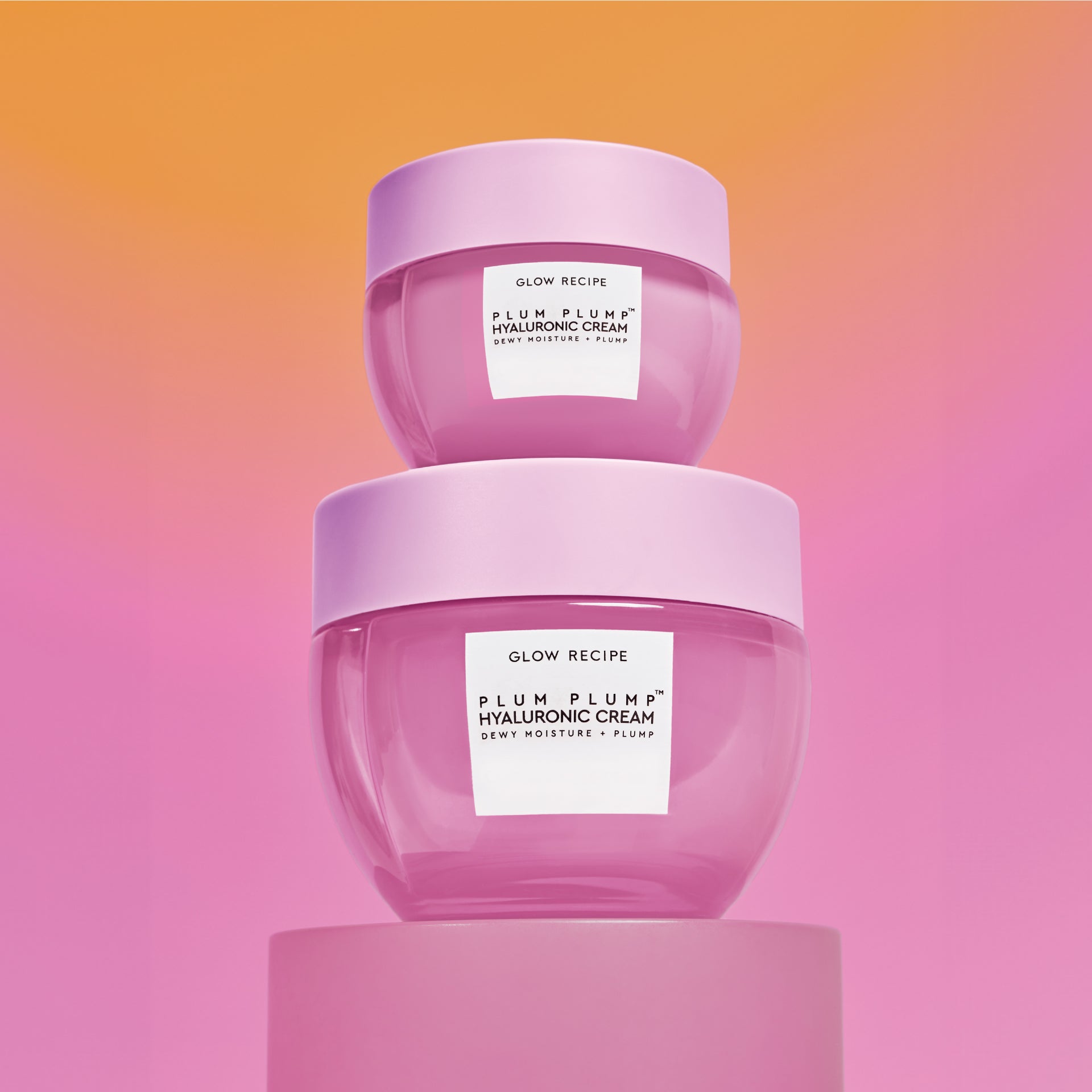 Mini Size (20ml) Plum Plump Hyaluronic Cream jars stacked on top of each other against an orange-to-pink gradient backdrop.