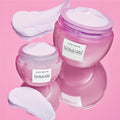 Two Mini Size (20ml) jars of Glow Recipe Plum Plump Hyaluronic Cream displayed side by side on a soft pink background.