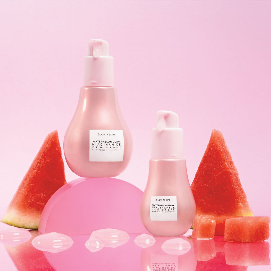 Two bottles of Watermelon Niacinamide bottles on pink background with watermelons in the background as well.