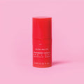 Red skincare serum bottle with 'Glow Recipe' on a pink background