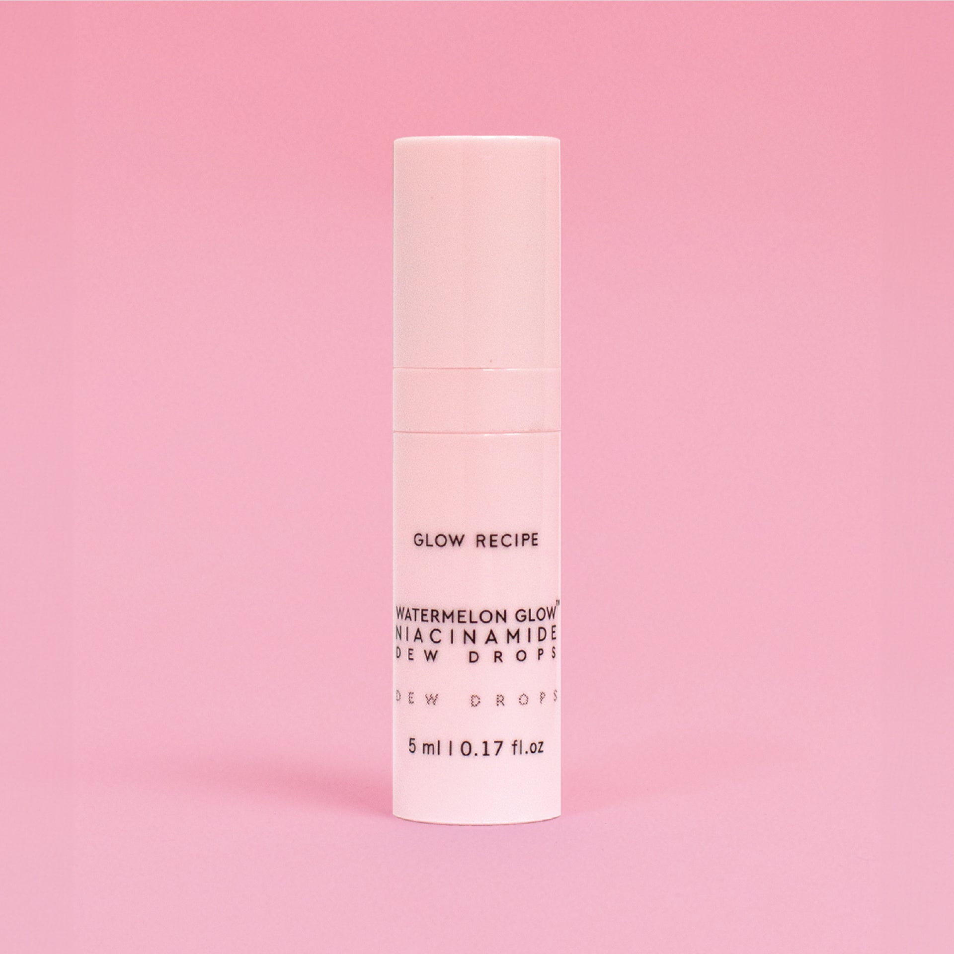 Skincare serum bottle with 'Glow Recipe' on a pink background