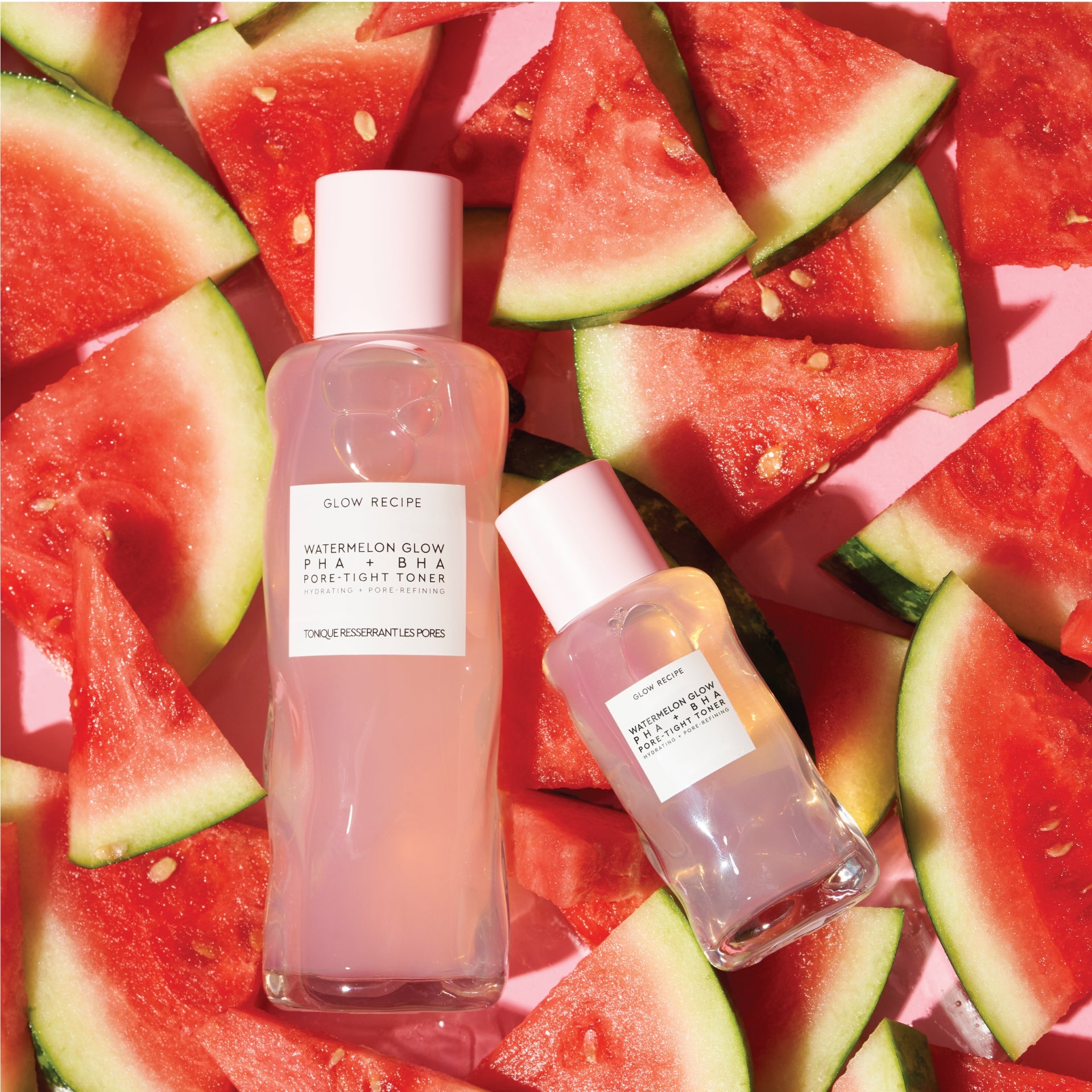 Two sizes of Watermelon Glow product bottles on top of watermelon background.