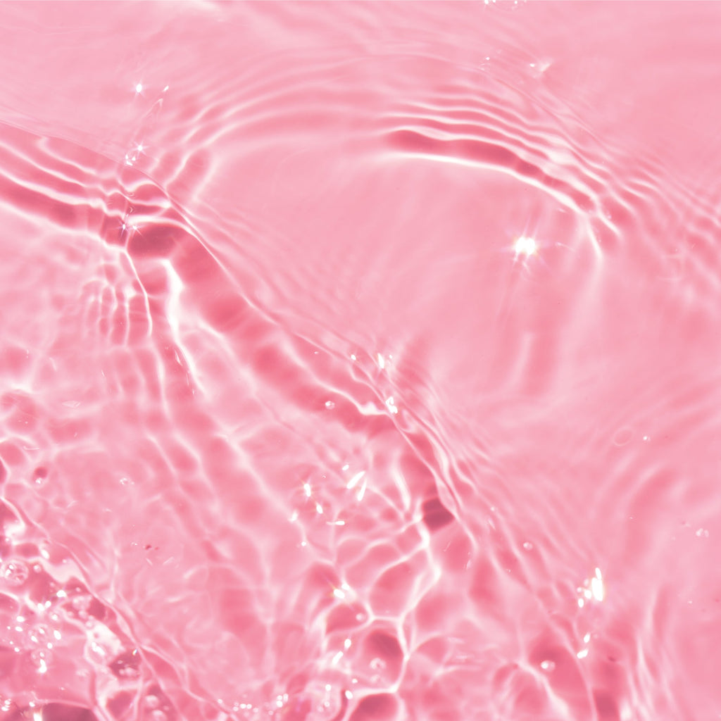 Clear toner liquid on top of pink background.