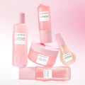 Set of pink skincare products with 'Glow Recipe' labels on a pink background