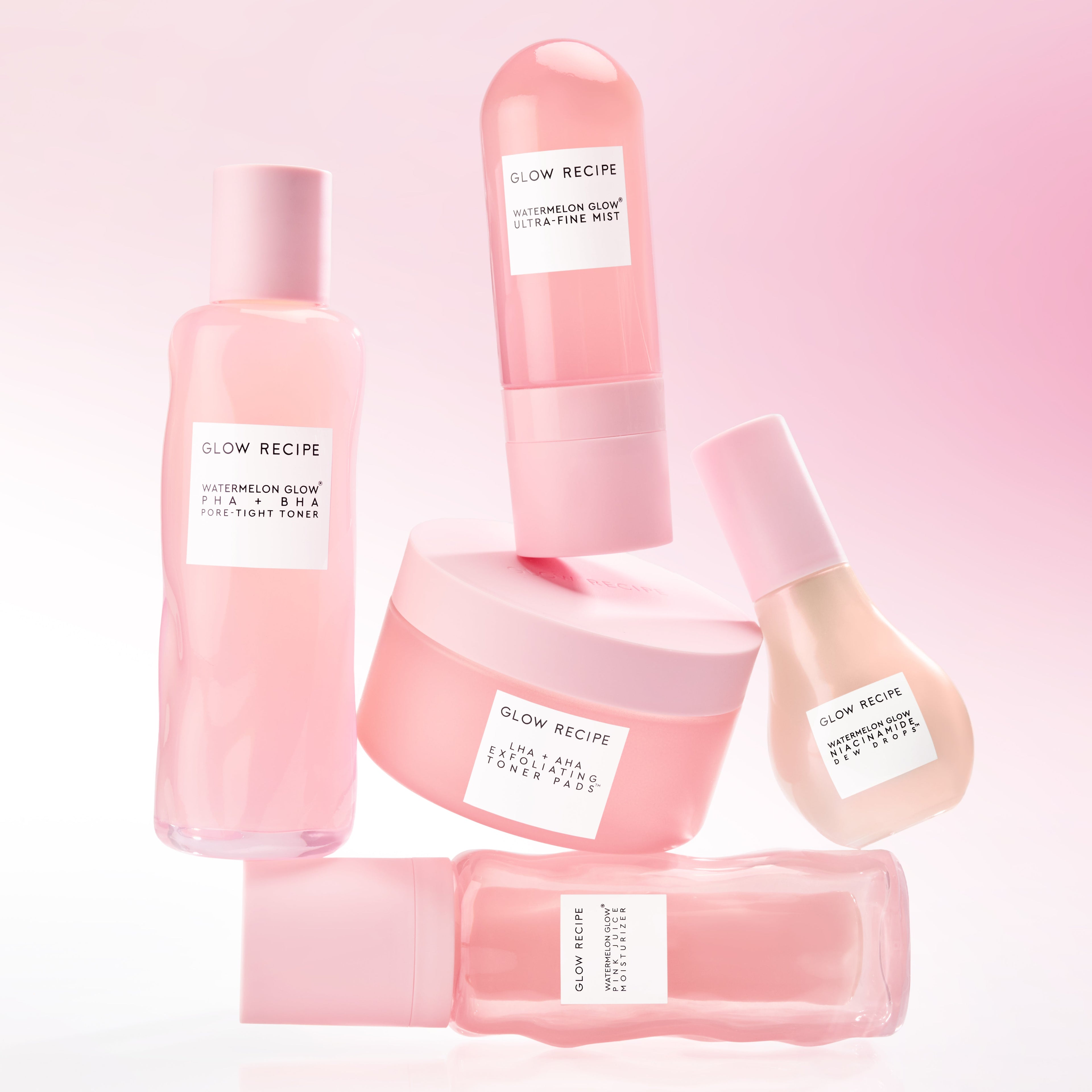 Set of pink skincare products with 'Glow Recipe' labels on a pink background